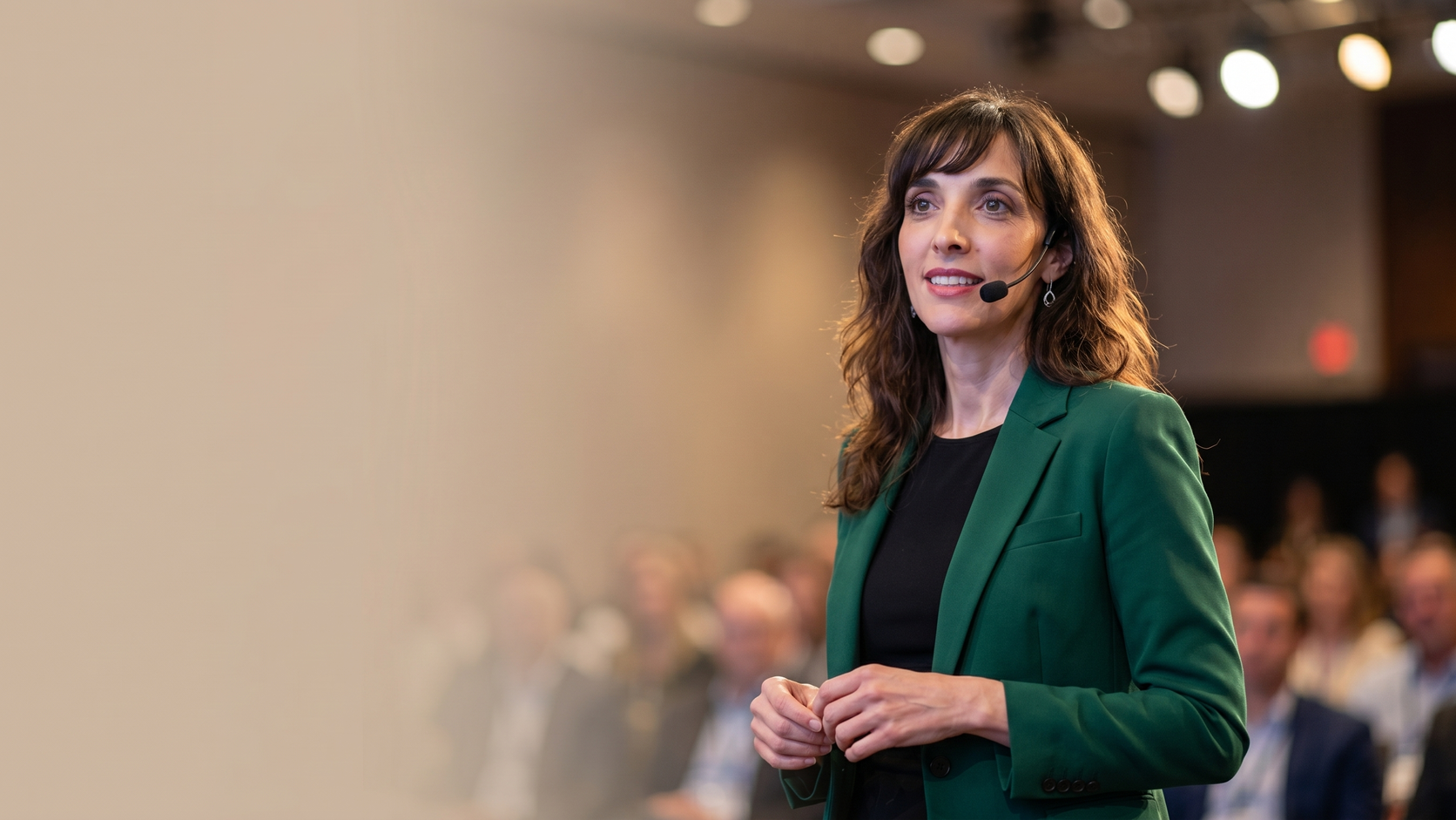 Josette Perrone speaking on a warmly lit conference stage
